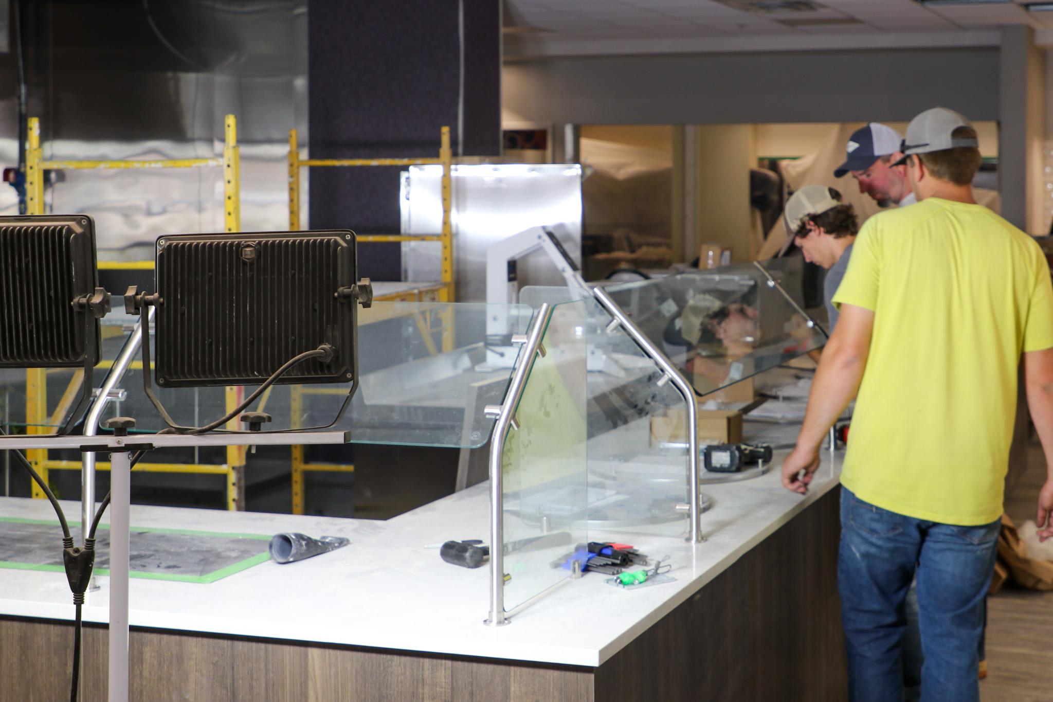 Men working construction around dining facility items